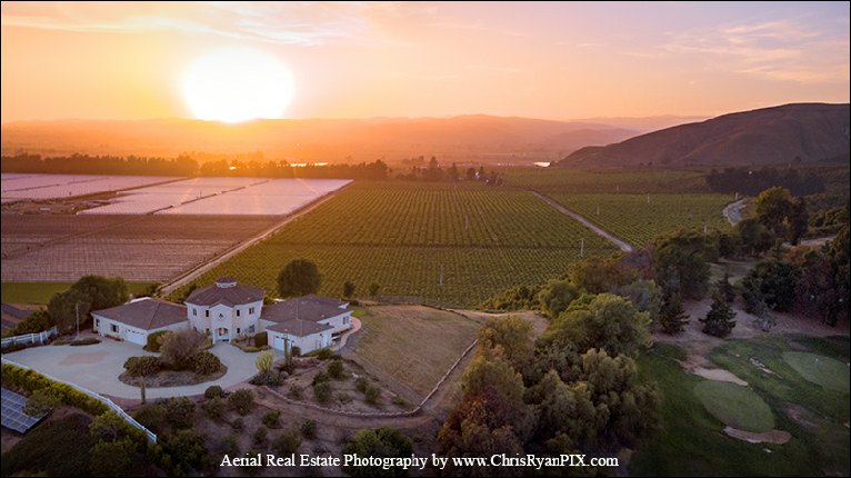 aerial real estate photography of home during sunset with scenic view