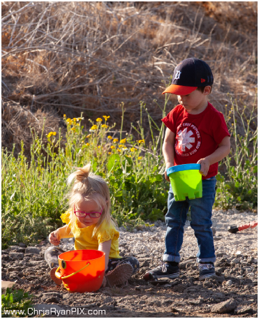 Two Children with buckets playing in hillsides (ChrisRyanPIX)