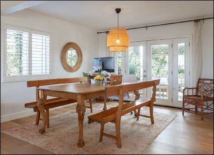 Interior Real Estate Photo of Dining Table with Carpet and Natural Lighting